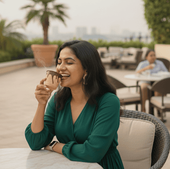 Woman enjoying tea from eco friendly edible biscuit cup in cafe